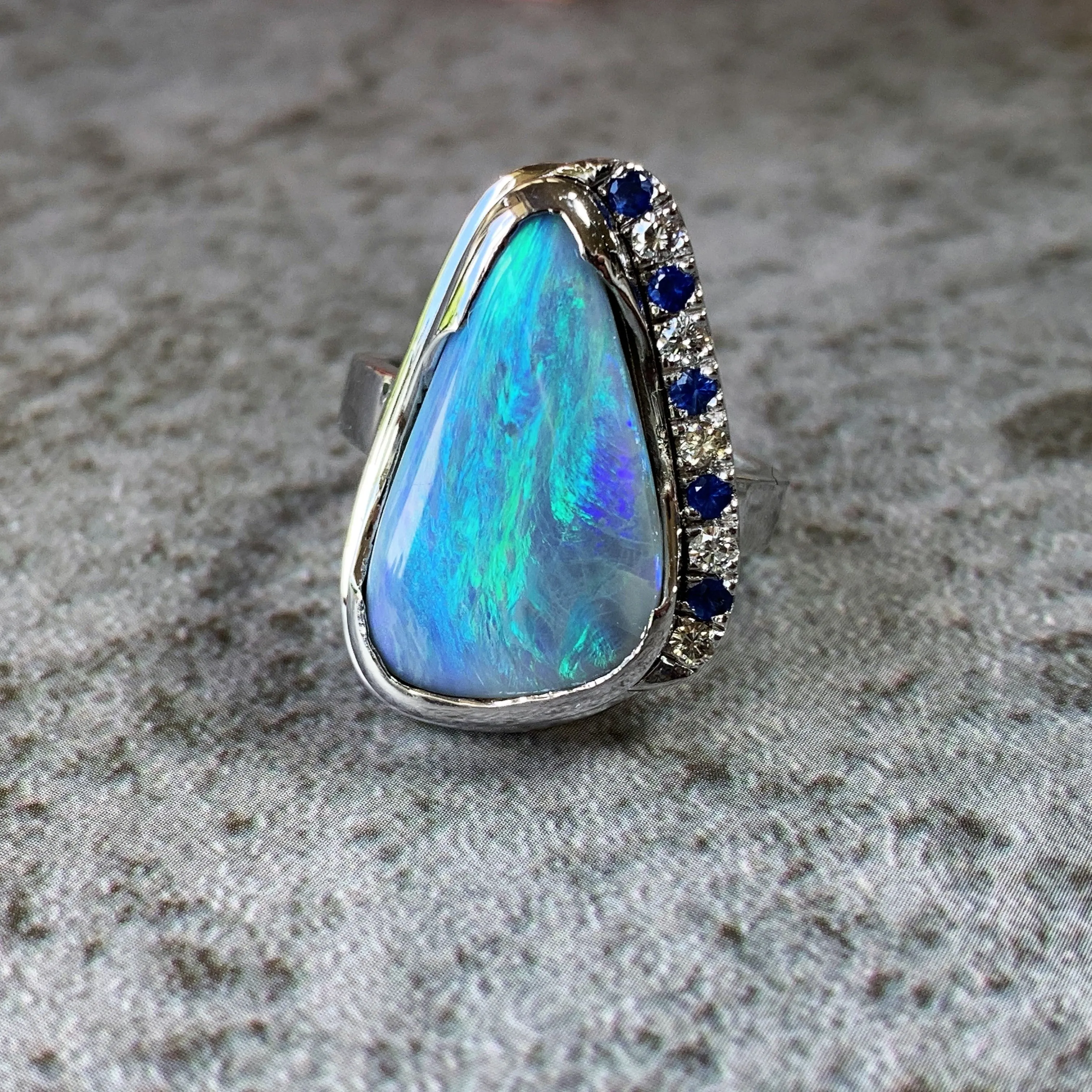 18kt White Gold bezel set Black Opal, Sapphire and Diamond ring